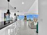 Expansive living area featuring elegant large-format marble-look tile flooring.