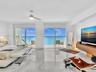 Wake up to breathtaking ocean views from the comfort of your bed in this spacious primary suite, featuring floor-to-ceiling sliding glass doors with d