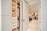 Custom built-in closet featuring integrated shelving, soft-close drawers with metallic pulls, and recessed lighting