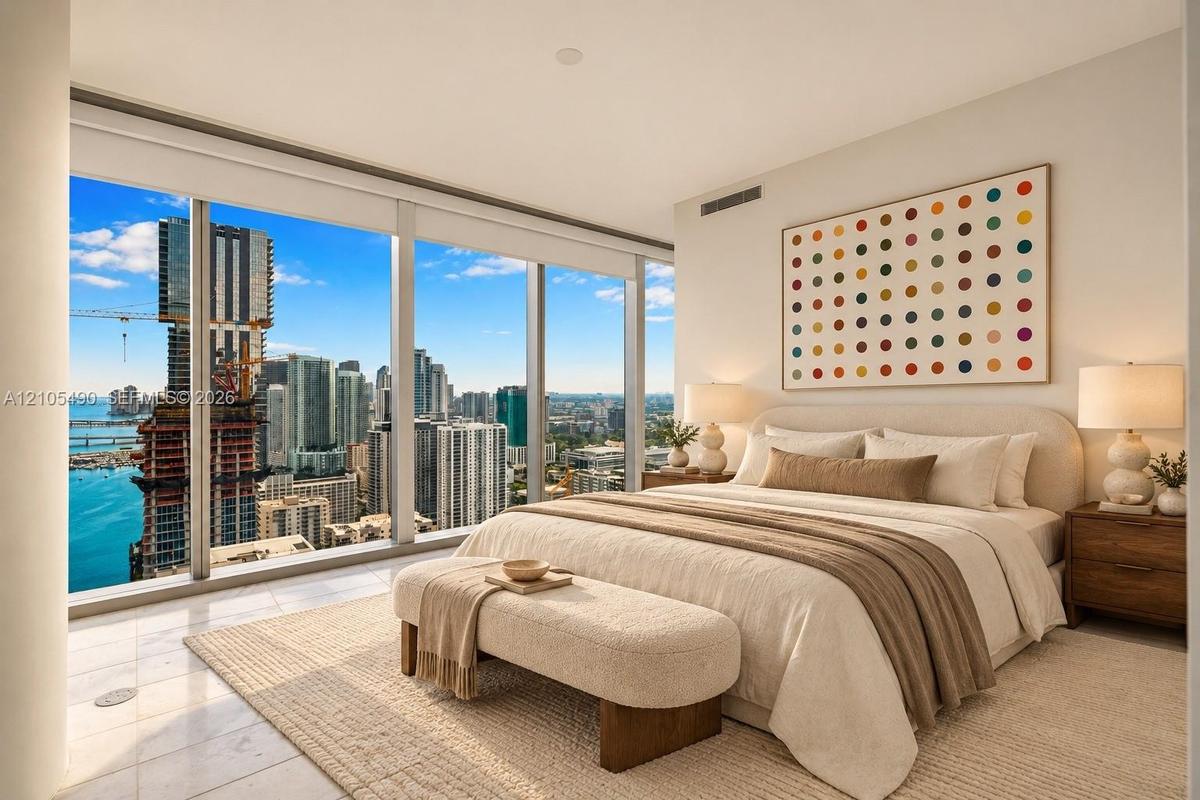 Floor-to-ceiling windows, neutral tile flooring, and urban water scenery