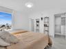 Bright and elegantly appointed interior featuring an expansive window that fills the space with natural light, a custom built-in closet organization s