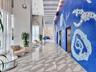 Step into an elegant, contemporary lobby with the intimate ambiance of a luxury boutique hotel, featuring distinctive designer finishes, stylish archi