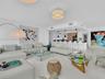 Spacious open-concept living area featuring Carrara marble flooring and recessed ceiling lighting.