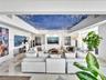 Elegant residents' lounge offering a sophisticated, boutique-style ambiance with artistic blue-and-white ceiling details, integrated speakers, illumin