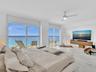 Wake up to breathtaking ocean views from the comfort of your bed in this spacious primary suite, featuring floor-to-ceiling sliding glass doors with d