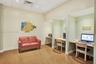 Dedicated workspace featuring recessed lighting, built-in desks, and wood-finish flooring