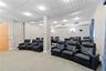 Tiered seating area featuring recessed lighting, a paneled ceiling, and neutral wall tones