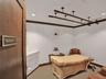 Built-in white vanity with solid-surface countertop, ceiling-mounted metal track system, crown molding, and recessed lighting