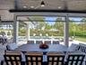 Covered patio featuring a stained wood plank ceiling, recessed lighting, a modern ceiling fan, retractable screens, and tile flooring
