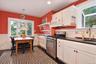 Kitchen with decorative black and white tile floor and seating area.