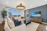 Spacious living area featuring large windows with wood-finish flooring.