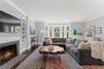 Large living room with a gas fireplace, built-in shelving and set beautifully with windows overlooking the gorgeous landscape. Exceptional for enterta