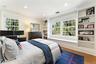 Bedroom with window seat and built-in shelving for extra storage