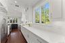 Sunlit and spacious updated kitchen with extensive counter space and custom cabinetry