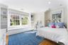 Bedroom with window seat and built-in shelving for extra storage