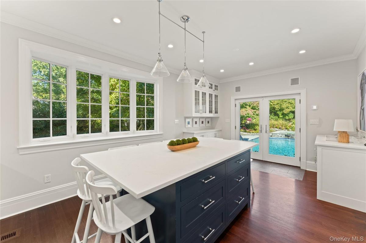 View of the sunny kitchen eat-in area looking out to the pool and gorgeous backyard