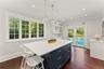 View of the sunny kitchen eat-in area looking out to the pool and gorgeous backyard