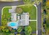 Top aerial view showcases the full breadth of the home, property size, pool and backyard