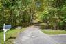 Meandering driveway leads to house with ample parking