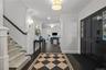 Dark wood-finish flooring with a contrasting staircase featuring white risers and a dark handrail