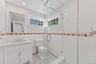 Full bathroom perfectly situated next to door with access to pool area for guest entertainment