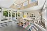 Window-lined porch/breezeway overlooks the pool, serves perfectly for indoor-outdoor entertaining, and effortlessly connects the main living spaces wi