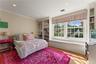 Bedroom with window seat and built-in shelving for extra storage