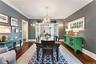 Spacious dining room with french doors leading to the window-lined porch/breezeway for easy entertaining
