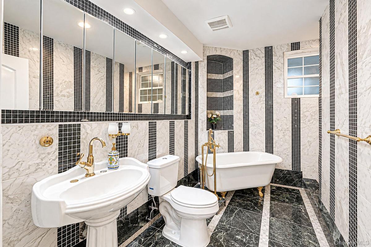 Bathroom One - ground level - pedestal sink, tub and stall shower