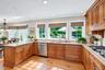 Custom Kitchen With Large Windows Overlooking Yard