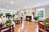 Formal Living Room With Fireplace, Hardwood Floors, and Beautiful Views of Nature