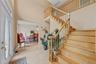Foyer with suspended lighting, a high ceiling, and a baseboard heating unit
