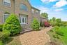Property entrance with brick siding and a lawn