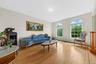 Living area featuring wood finished floors and a baseboard heating unit