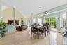 Dining area with plenty of natural light, suspended lighting, a fireplace, and lofted ceiling