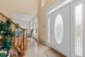 Foyer featuring a baseboard heating unit, a high ceiling, and light tile patterned floors