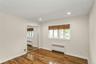 Unfurnished bedroom featuring radiator, dark wood-type flooring, a closet, and recessed lighting