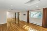 Unfurnished bedroom with a baseboard radiator, wood-type flooring, a closet, and recessed lighting