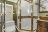 Bathroom with a shower stall and vanity