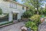 Property entrance with a patio area and stone siding