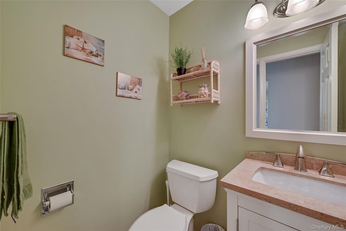 Powder Room with white vanity with a  integrated sink
