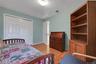 Recessed lighting, wood-finish flooring, and white paneled doors in second bedroom with double closet