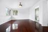 Dark wood-finish flooring, white walls, and a ceiling-mounted light fixture