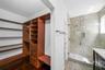 Walk-in closet with built-in shelving, drawers, and hanging rods