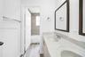 Double vanity with integrated sinks, framed mirrors, and wood-finish cabinetry