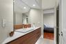 Floating wood-finish vanity with an integrated rectangular sink