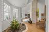 Vaulted ceilings, plank wood-finish flooring, recessed lighting, and a stone-clad architectural column