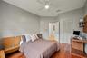 Hardwood-finish flooring, built-in shelving, folding louvered closet doors, and recessed lighting