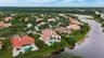 Property with red tile roofing, a swimming pool, and a paved patio area