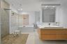 Floating wood-finish vanity with an integrated rectangular sink and polished chrome faucet